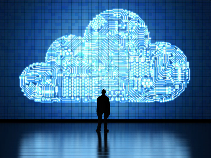 Man looks at illustration of cloud infrastructure