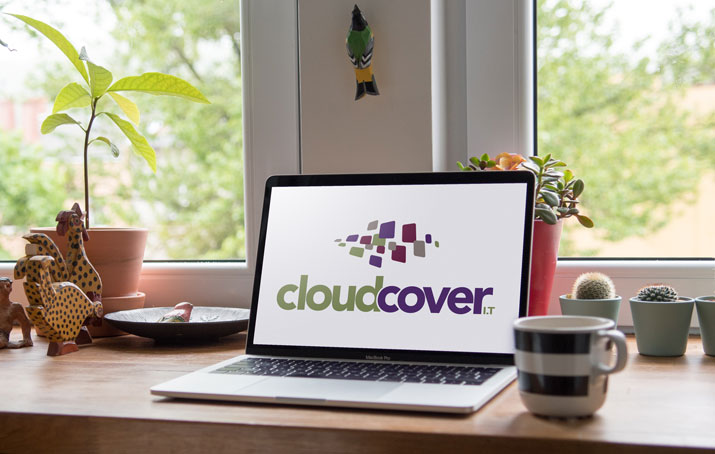Laptop with Cloud Cover IT logo on the screen